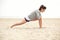 Female Athlete Doing Stretching Exercise on the Beach