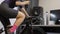 Female athlete is drinking water during indoor cycling training. Fitness exercises