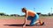 Female athlete getting ready for race on running track 4k