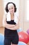 Female Athlete In Good Fit Posing Against Fitball in Gym.