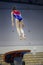 Female athlete gymnast performing a leap at the championship
