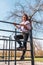 female athlete having fun climbing on sport metal structure outdoors