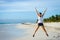 Female athlete jumping at beach