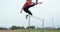 Female athlete jumping over hurdles on a running track 4k