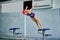 Female athlete jumps to the pool water. Middle-aged woman professionally engaged in swimming