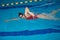 Female athlete practicing freestyle stroke in water