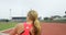 Female athlete practicing shot put throw at sports venue 4k