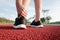 Female Athlete Runner Ankle Injury While Jogging in Running Track, Sport Woman Having Pain Her Ankles During Exercise Running.