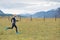 Female athlete running on rough terrain.