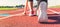 Female athlete on the starting line of a stadium track