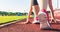 Female athlete on the starting line of a stadium track