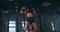 Female Athlete Swinging On Chin Up Bar. Strong women Doing Chin-ups On Gymnastic Bars In Gym. Professional Athlete Does