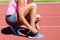 Female athlete tying her running shoes