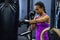 Female athletic practicing boxing in fitness center