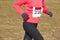 Female athletic runner on a cross country race. Outdoor circuit