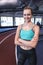 Female athletic standing with arms crossed in fitness center