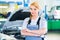 Female auto mechanic working - car workshop
