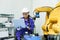 female automation machine engineer student study and inspection control robot arm machine in university or factory workshop. ai