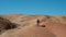 Female Backpacker Hiking on Hills in Steppe