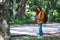 A female backpacker looking for direction on the map while traveling on a mountains road