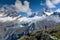 Female backpacker standing on a grassy knoll and looking at the mountain landscape of the Cordillera Blanca