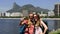 Female backpackers tourists with smartphone in Rio de Janeiro with Christ the Redeemer in background.