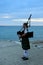 Female Bagpiper on the Pier at Twilight
