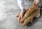 Female baker holds fresh baked French baguette. Homemade sourdough bread. Homemade food. Food preparation