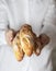 Female baker holds fresh baked French baguette. Homemade sourdough bread. Homemade food. Food preparation