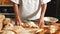 Female baker kneading a dough