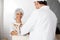 Female Baker Receiving Bread Waste From Male Colleague