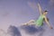 Female ballet dancer sitting on cloud in dragonfly green costume