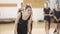 Female ballet dancer suffering ankle pain dancing in slow motion indoors. Portrait of Caucasian girl practicing ballroom