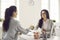 Female bank manager shakes hands with a client while signing a financial investment agreement.