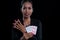 The female banker clamp red dices between her fingers and holding Hearts Suit Straight Flush