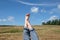 Female bare feet with red nails against summer landscape