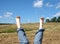 Female bare feet with red nails against summer landscape