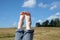 Female bare feet with red nails against summer landscape closeup