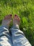 Female barefoot resting on the green grass background