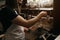 A female barista doing stuff with a coffee machine