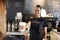 Female Barista Serving Customer With Takeaway Coffee In Cafe