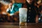 Female barman pours aerated water into a glass