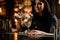 Female bartender decorated the murky transparent alcoholic cocktail drink with a twig with flowers