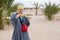 Female in bedouin clothes standing in desert