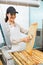 Female Beekeeper Brushing Honeycomb