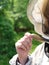 Female beekeeper wearing protective suit