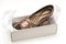 Female beige shoes on shoe box