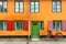 Female bicycle waiting for rider near yellow walls of historical building in traditional style of Copenhagen, Denmark.