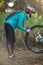 Female biker repairing mountain bike