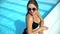 female in bikini enjoying summertime, swimming pool at luxury hotel, relax
